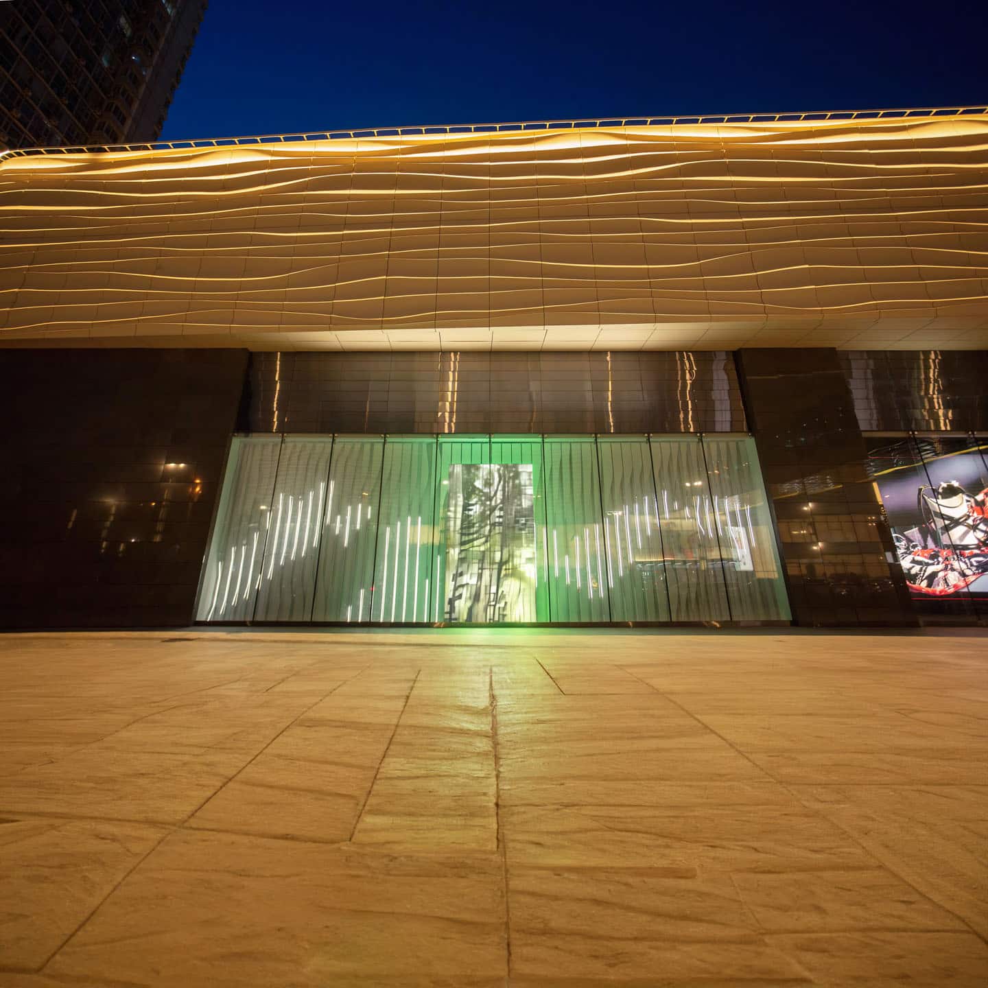 Alex Fischer & Polymetis, In Situ 在司徒, 2021, 20'x60' acrylic, steel, lights. 18'x9' LED Display. 24h animation loop as seen installed south west exterior Charter Mall Harbin, China. Photographed at night.